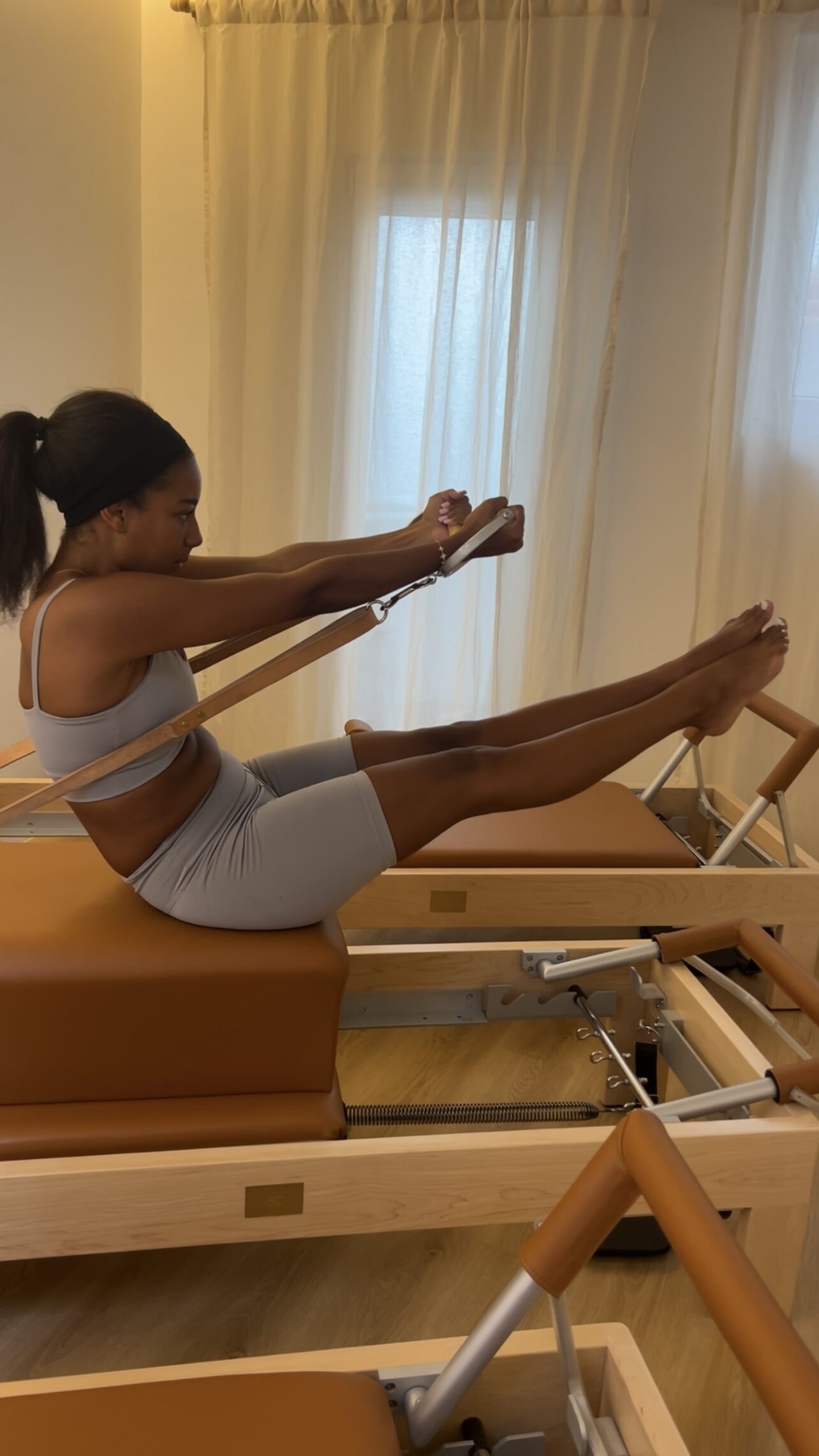 Pilates practice on the reformer by the studio window at Soul Circle
